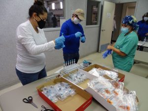Diversified Interiors employees handling test kits