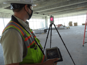 One on-site Diversified team member looking at a tool used for laser scanned point cloud technology